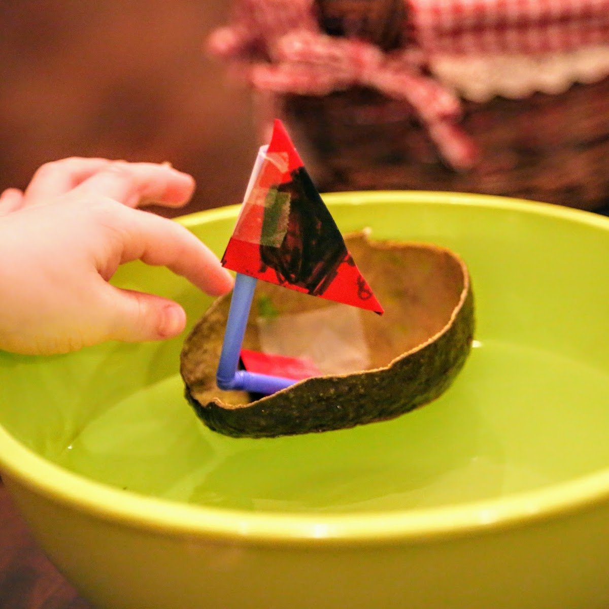 hand pushing avocado boat