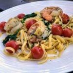 shrimp and garlic pasta on white plate