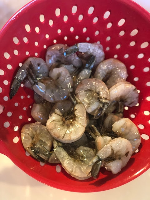 raw shrimp in strainer