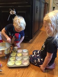 kids baking muffins on kitchen floor