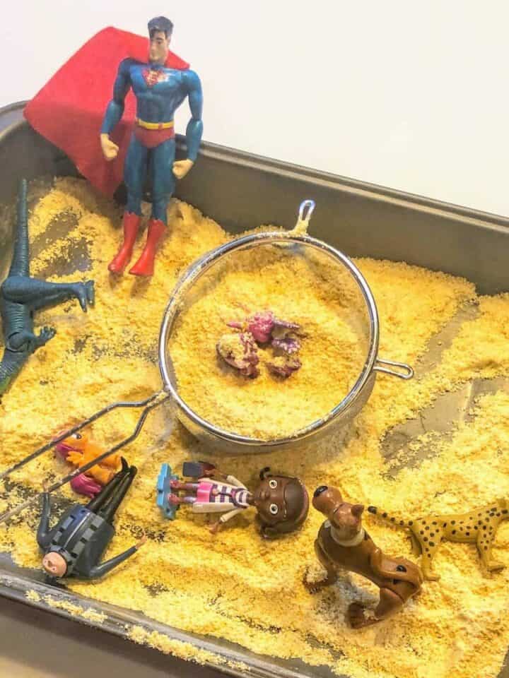 kitchen pan filled with cornmeal and toys