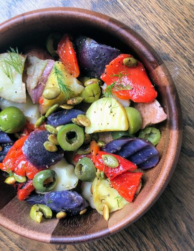 Three Potato Salad with Roasted Red Peppers & Olives, in a bowl