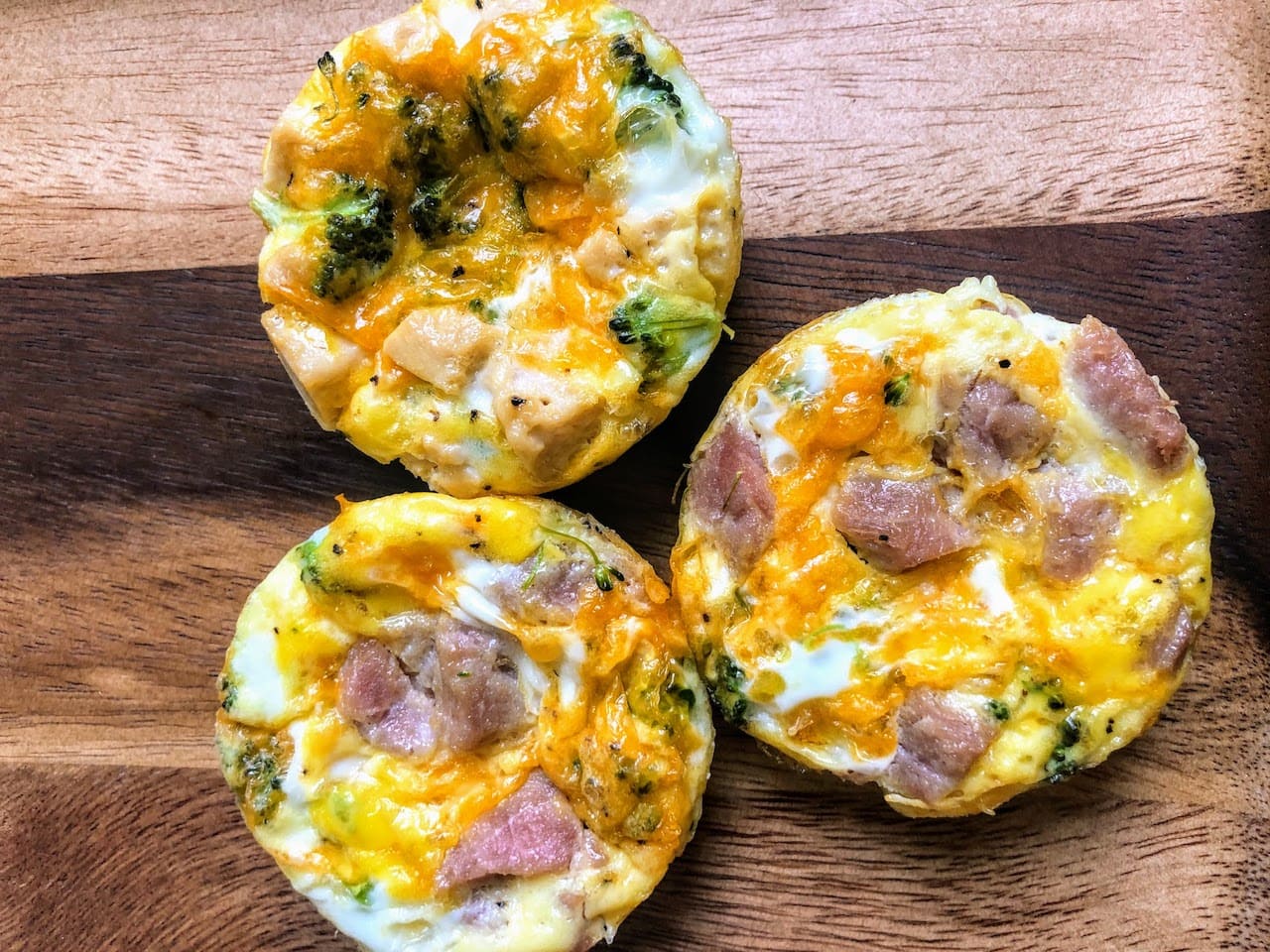 three mini egg bites baked with ham, broccoli and cheese