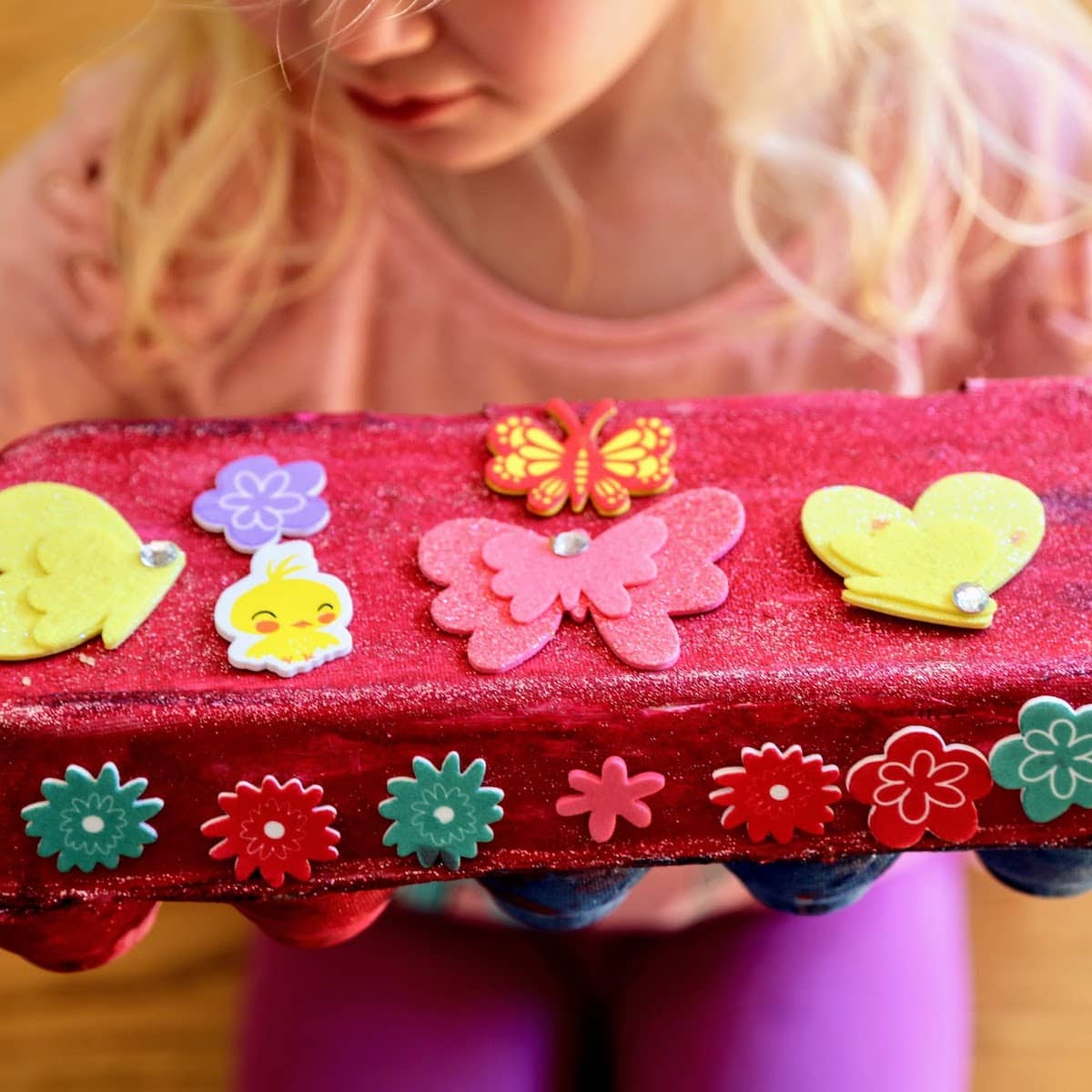 child holding egg carton treasure chest