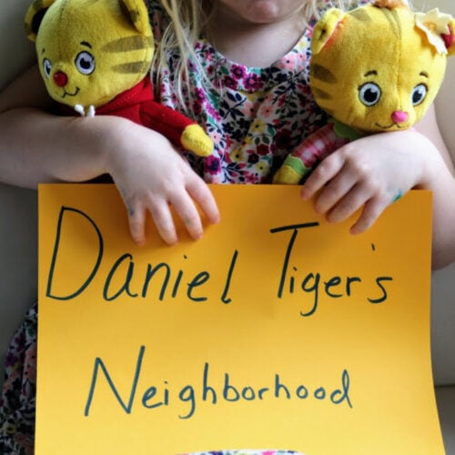 child holding sign that says Daniel Tiger