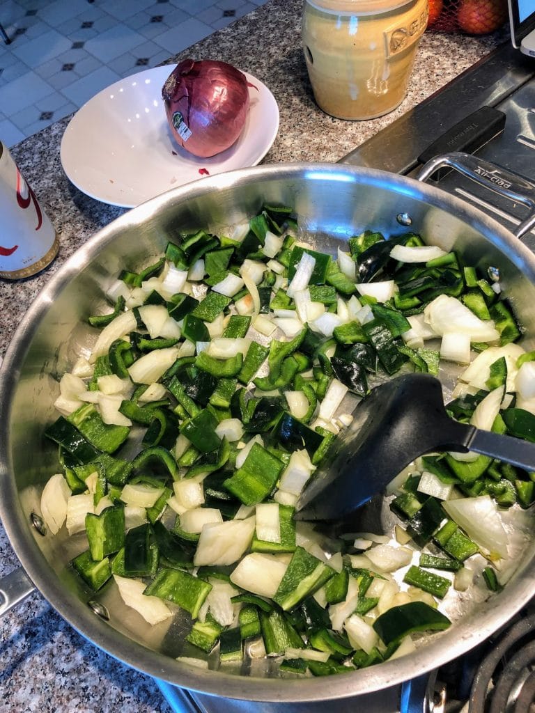 Stirring-poblano-peppers-onion-and-garlic