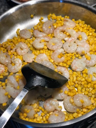 Stirring shrimp and corn