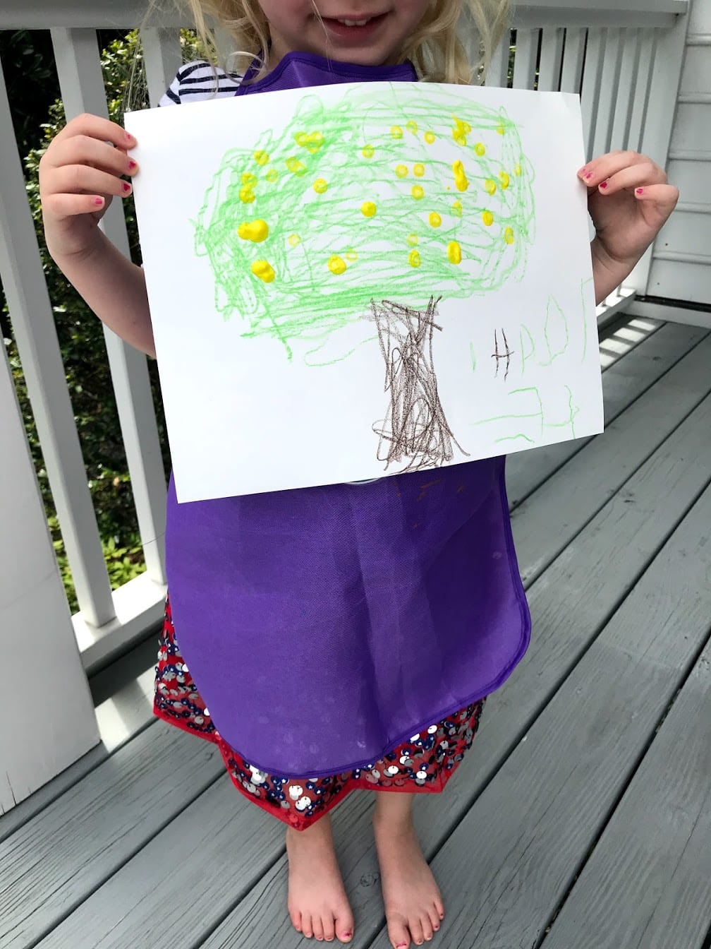 Childs holding Grapefruit tree