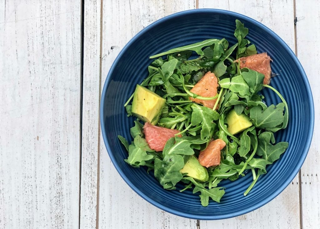 Grapefruit, Avocado & Arugula Salad on white table