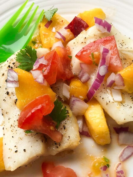 baked cod and peach salsa on plate