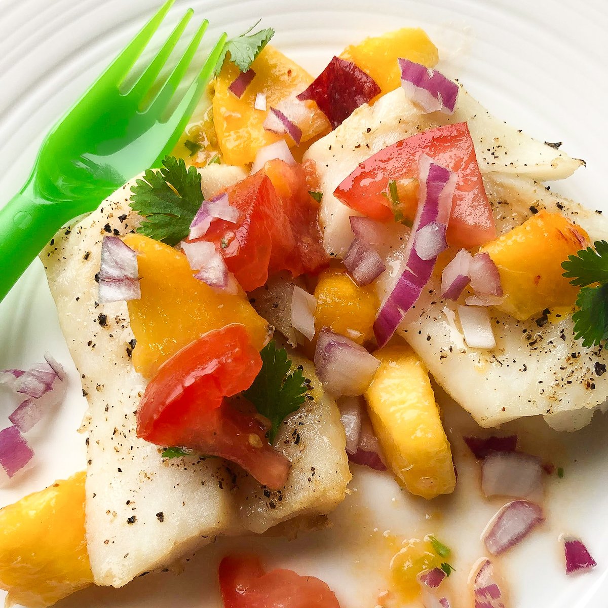 baked cod and peach salsa on plate