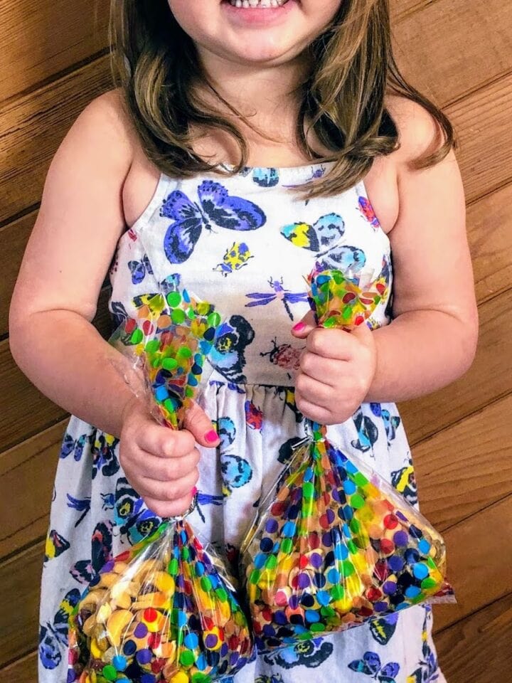 child holding bags of trail mix