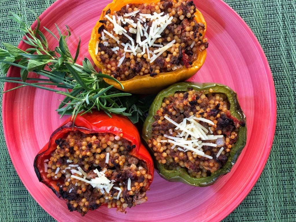 Stuffed Bell Peppers with Beefy, Cheesy Yumminess on pink plate