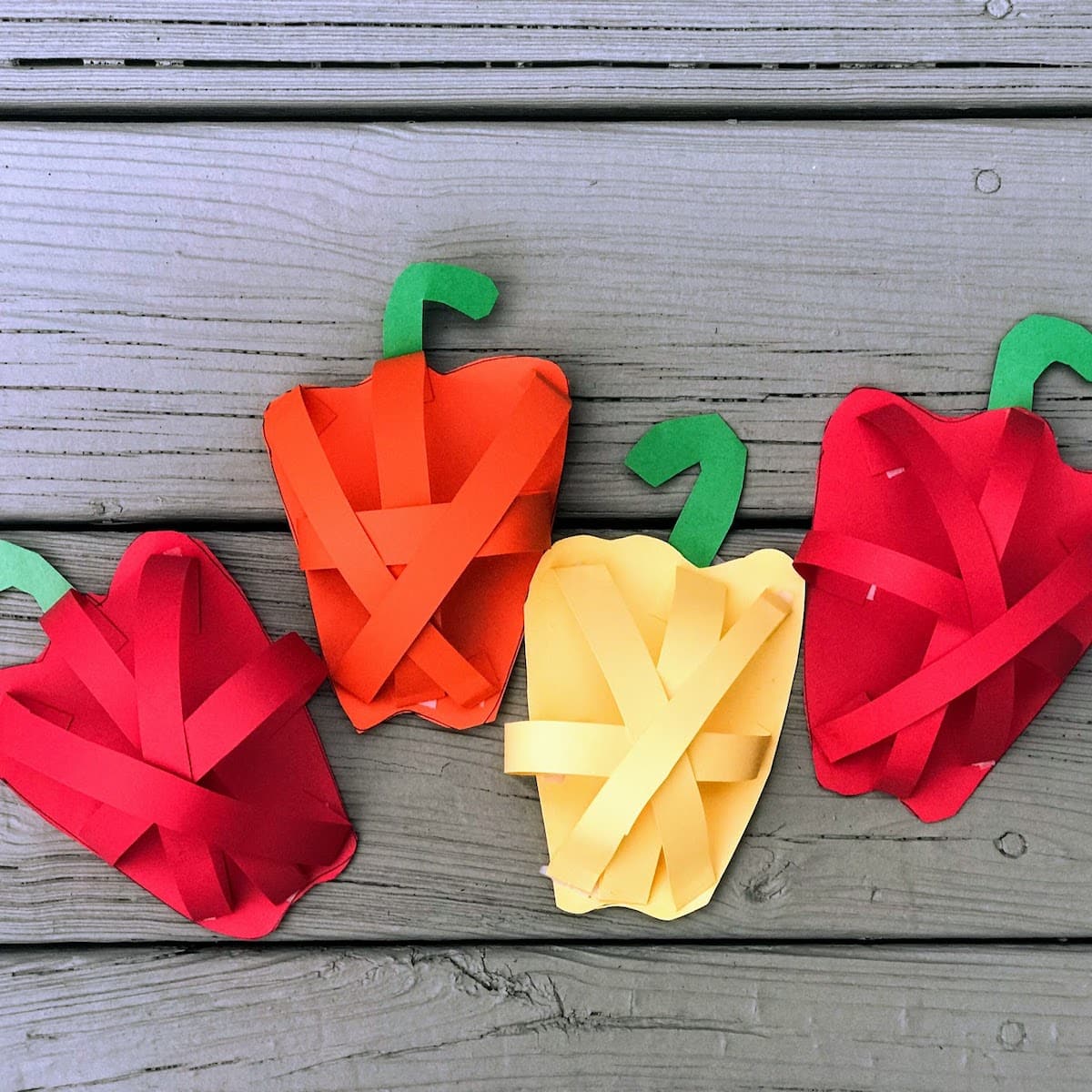 four paper bell peppers in different colors, for pop-up peppers craft