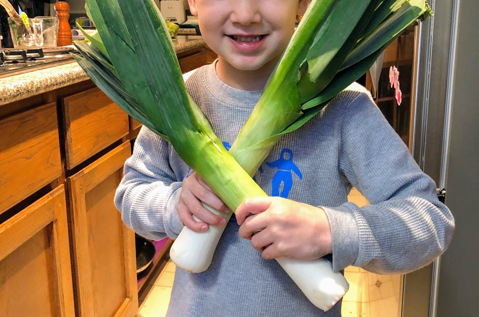 child holding leeks