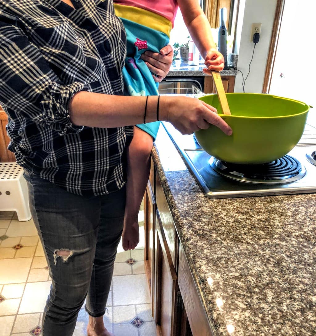 Mom daughter mixing bowl with spoon