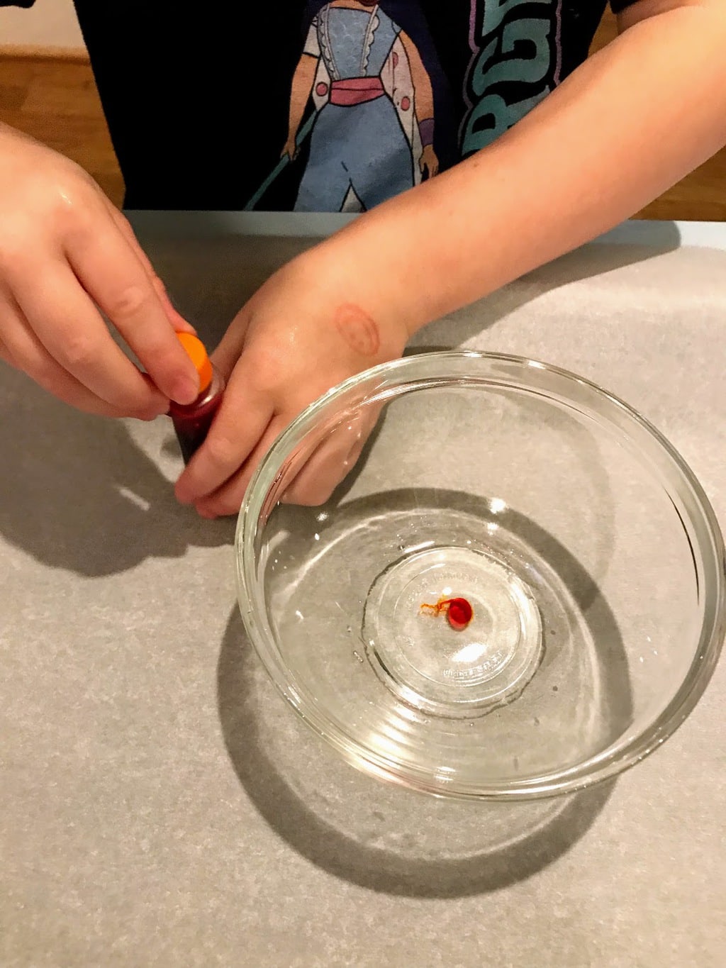 adding food coloring to bowl