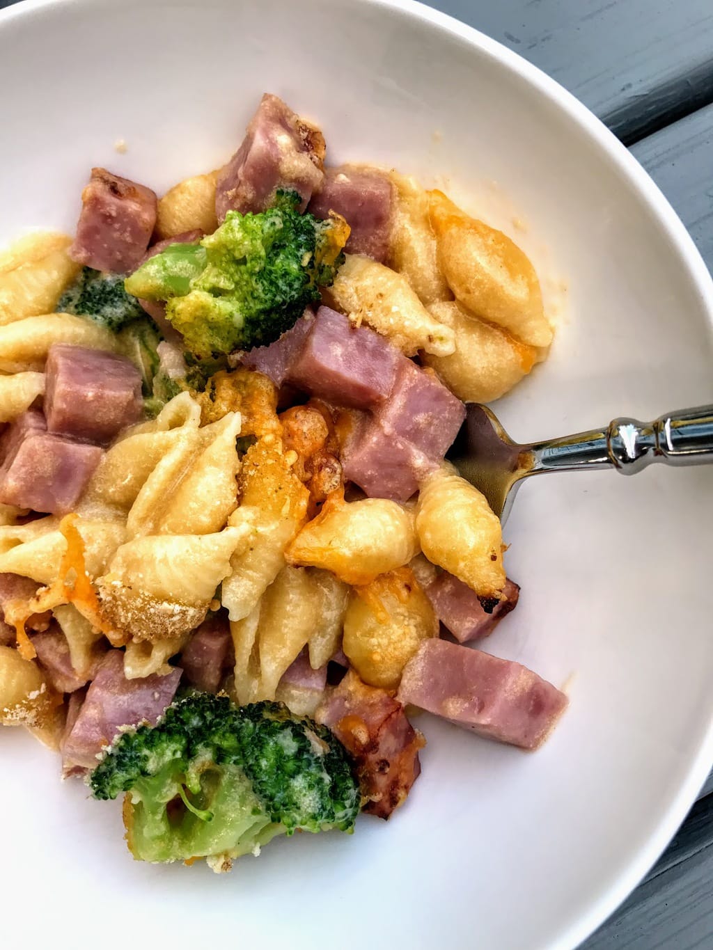 bowl of shell mac and cheese with broccoli and ham