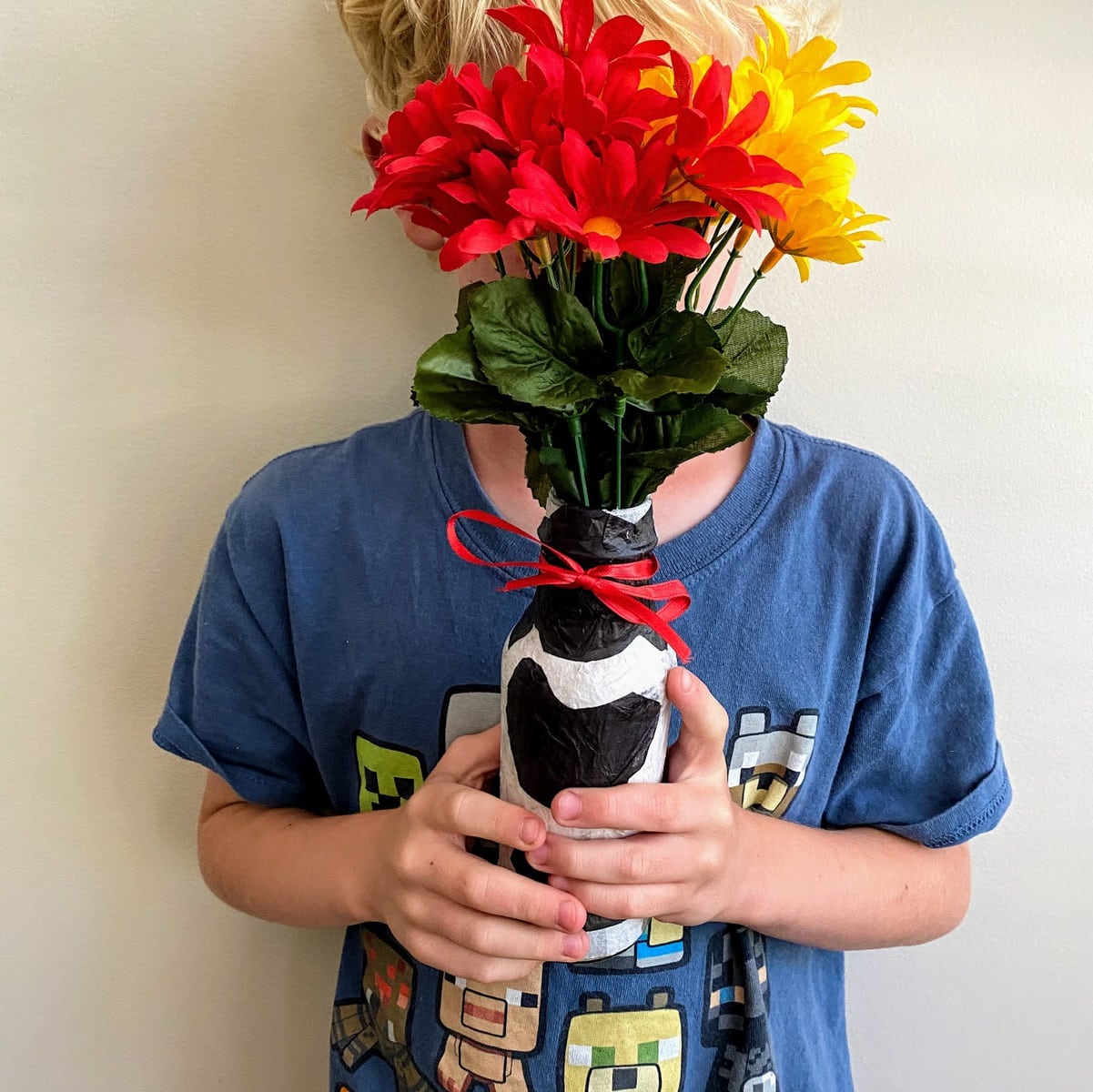 boy holding tissue paper vase