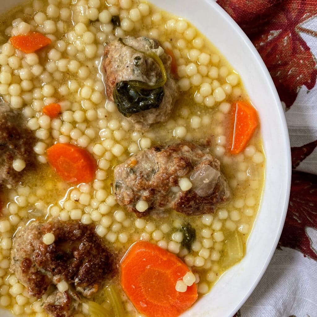 close up of turkey meatball italian wedding soup in bowl