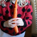 child holding carrot
