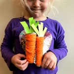 child holding play food carrots1
