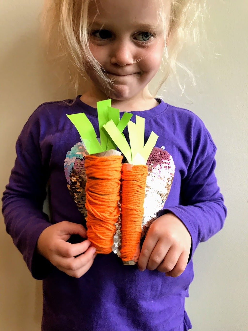 child holding play food carrots1