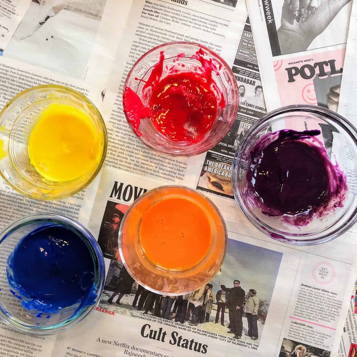yellow, red, blue, orange and purple egg yolk paint in bowls