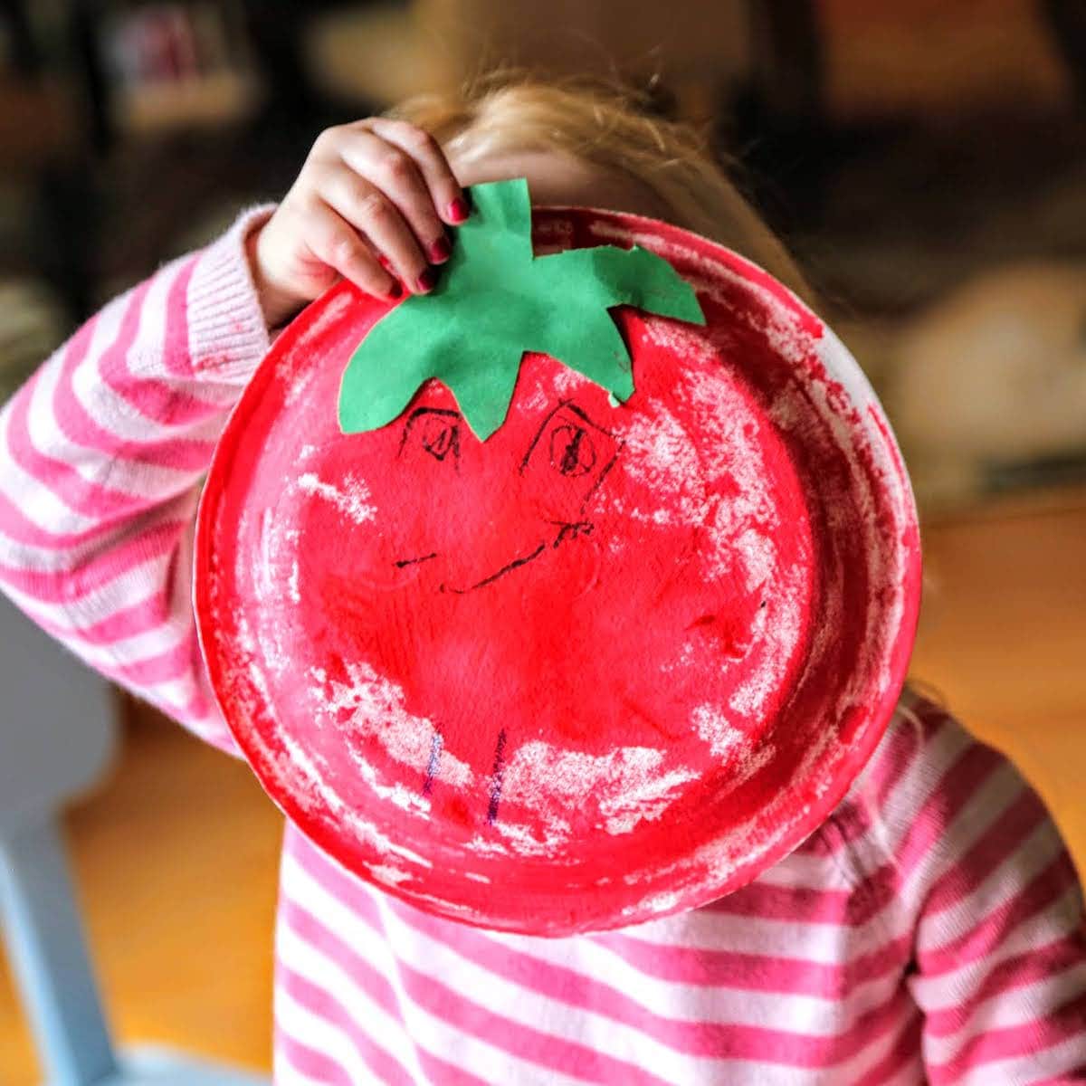 girl holding her tomato art