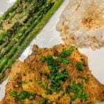 chicken, rice and asparagus on white plate