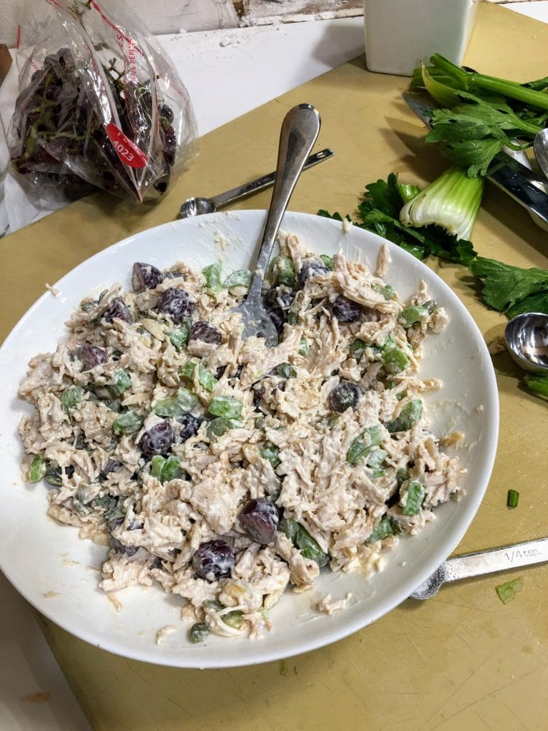 White Bowl of Mixed Chicken Salad, Sitting on Manila Cutting Board
