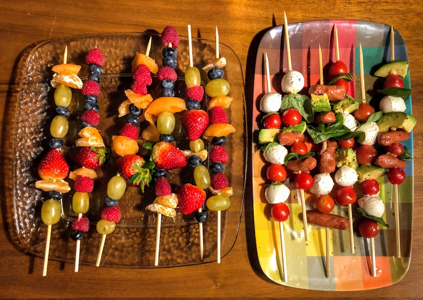 collection of fruit and cheese and meat kabobs