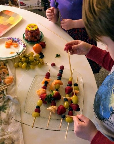 Kids assembling Fruit Kabobs 