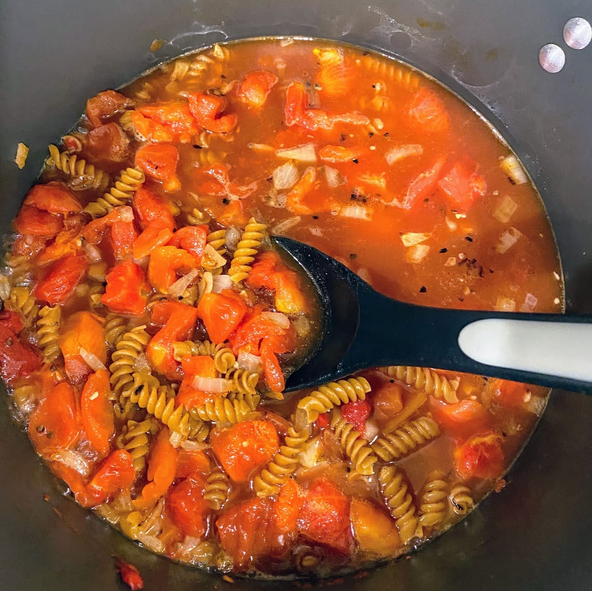 cooking pasta in tomato sauce