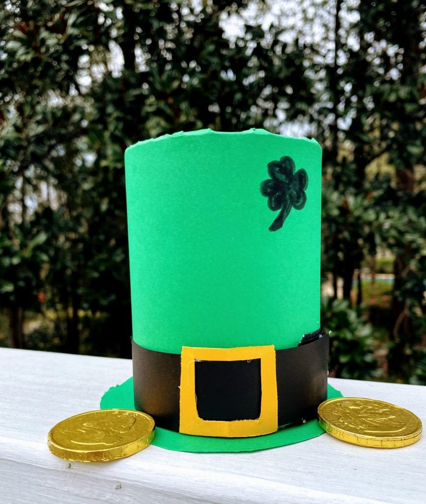 Green Leprechaun hat with coin treasures next to it