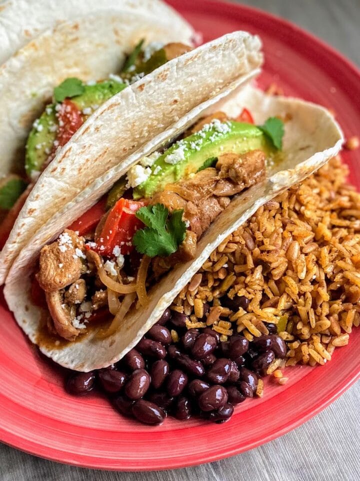 soft tacos with fajita chicken, rice and beans