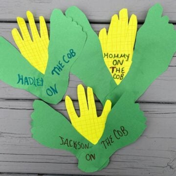 colored paper in shapes of kids' hands and feet like corn on the cob