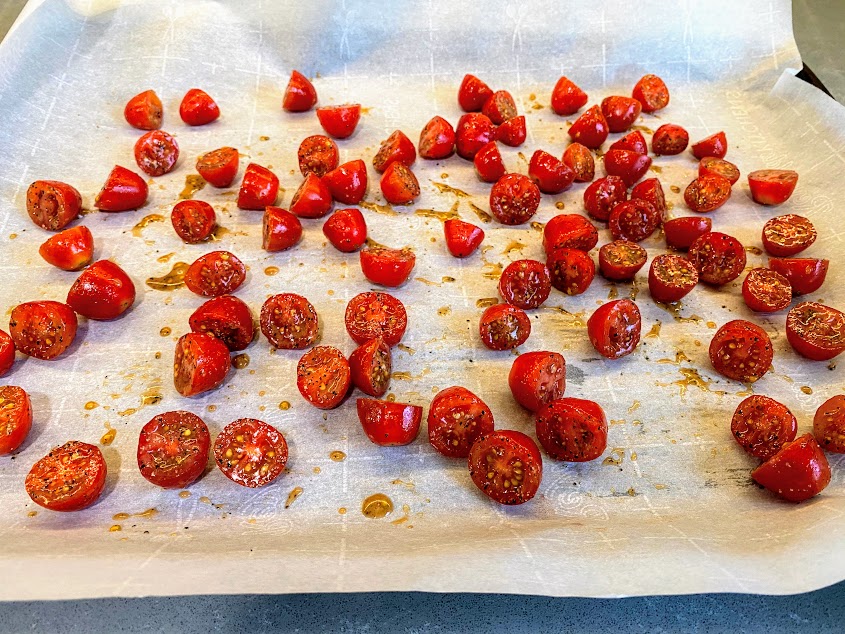 baking sheet with parchment paper and cut baby tomatoes