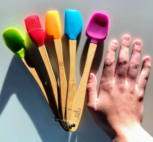 five mini utensils with bamboo handles and different colored heads
