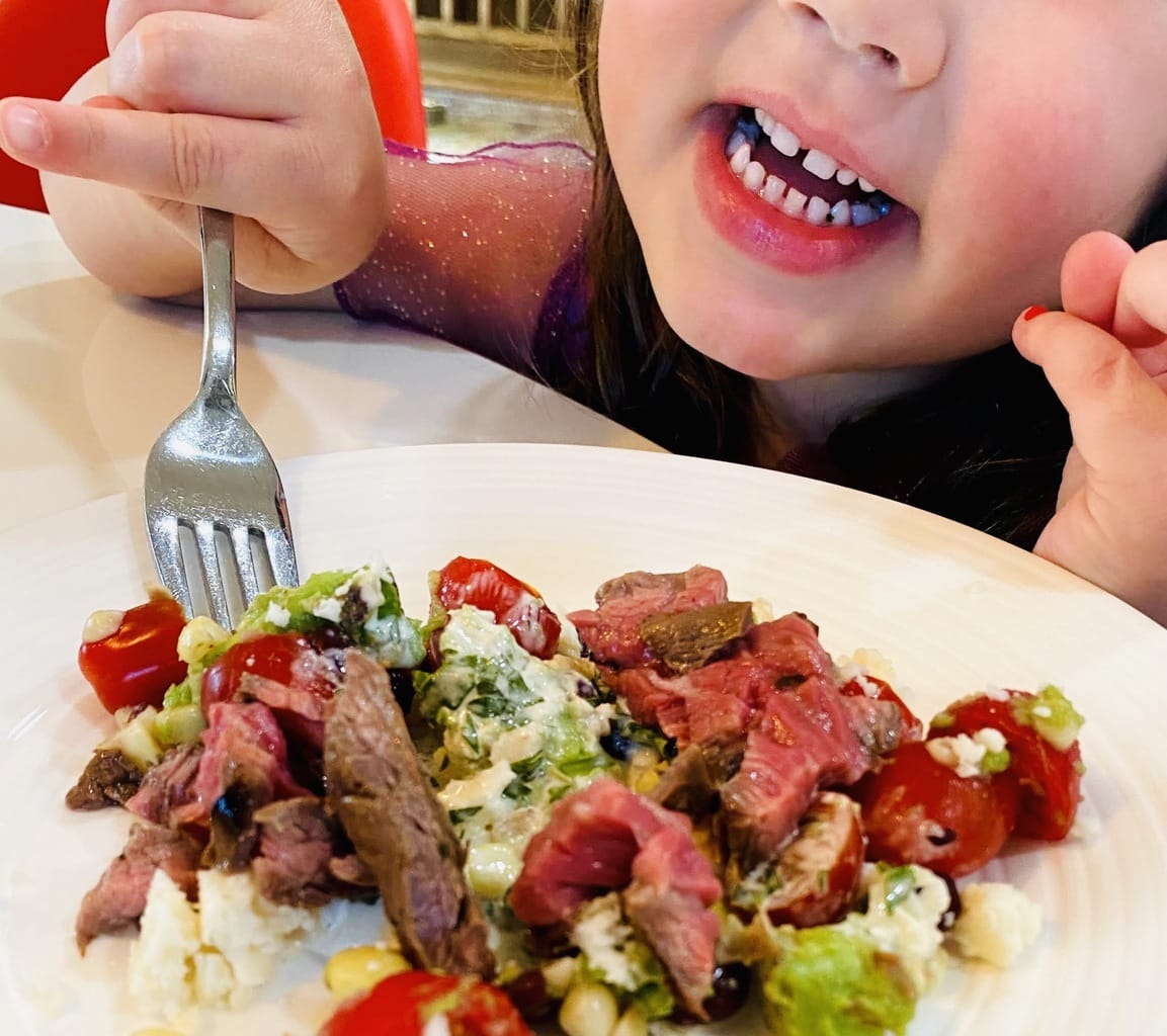 Child-happily-eating-carne-asada