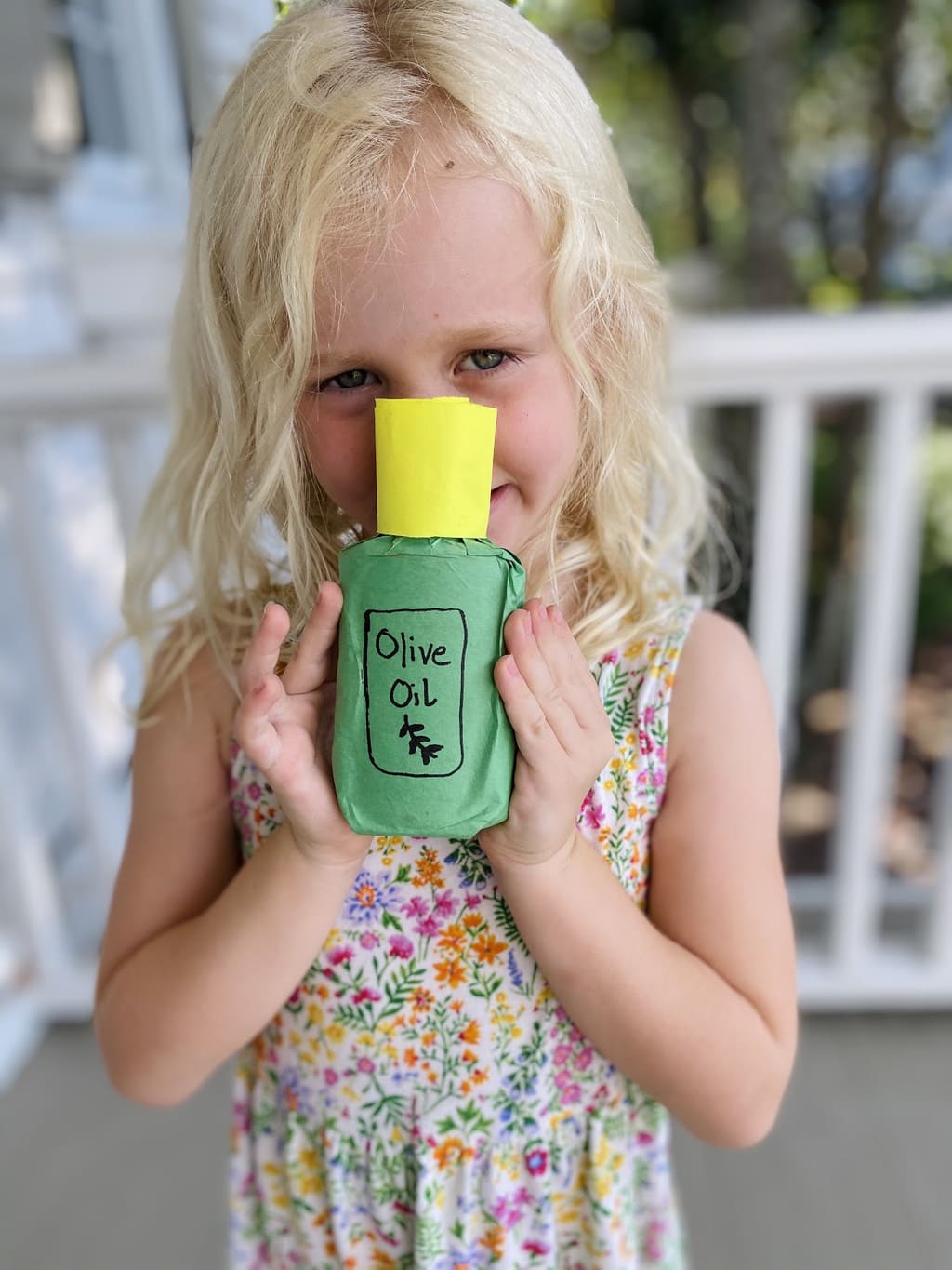 girl holding olive oil bottle craft