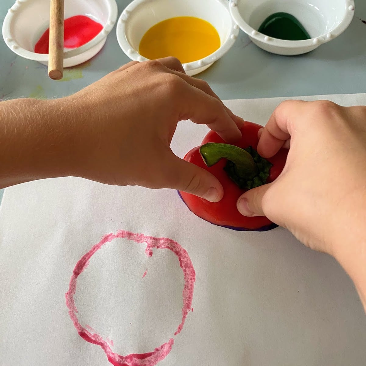 stamping a painted bell pepper top onto paper