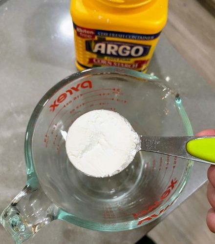Argo cornstarch container, tablespoon of cornstarch and a pyrex of water