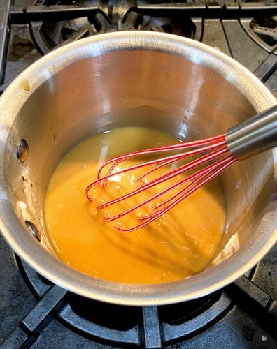 whisking sauce in pan for orange sesame chicken 2