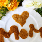 Pancakes in shape of a heart and the word MOM