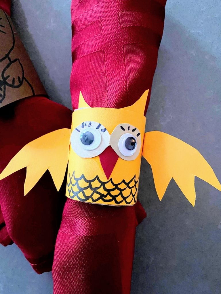 DIY yellow owl napkin ring holding red napkin