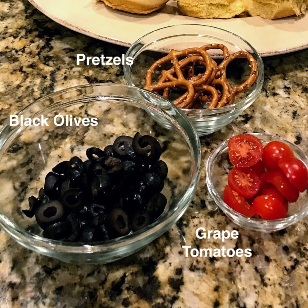 olives, pretzels and tomatoes for christmas sliders 