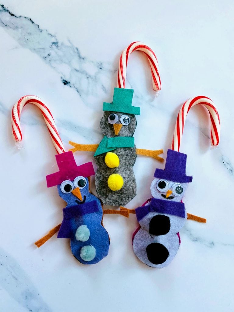 three snowmen candy cane holders