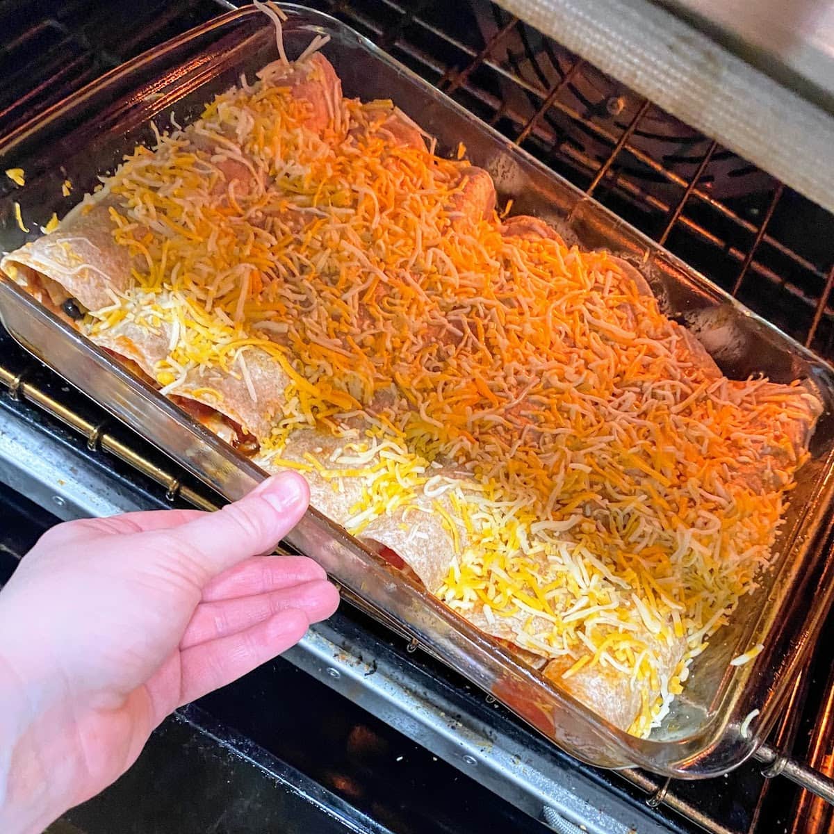 placing enchiladas in oven