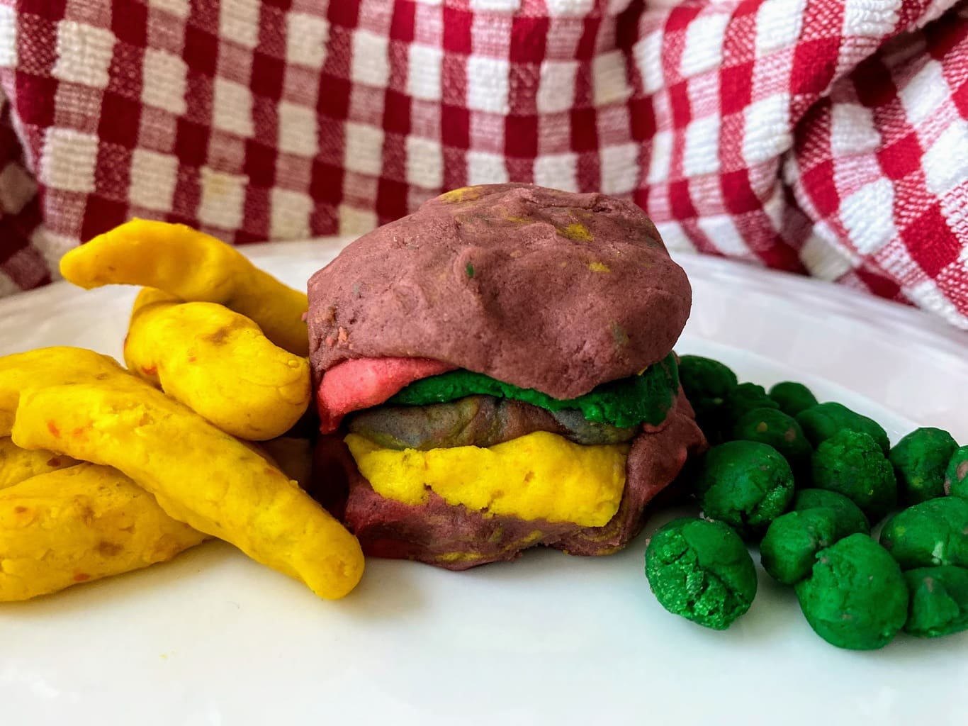cheeseburger, fries and peas made from play dough